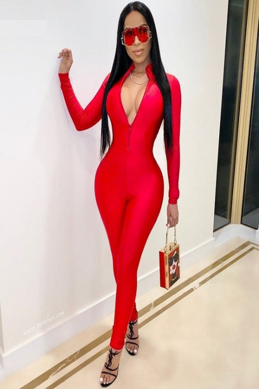 Unleash your boldest self in this show-stopping mock neck jumpsuit. Crafted from lustrous shiny  