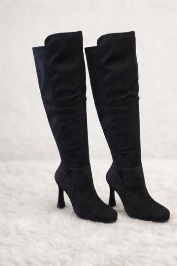 Step into bold sophistication with these striking pointed toe high heel boots.